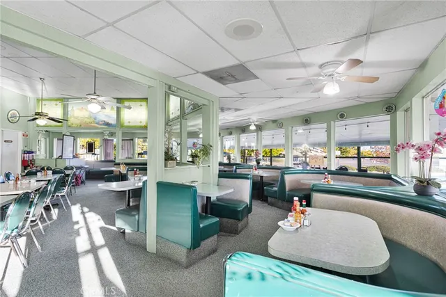 a living room with lots of furniture and view kitchen