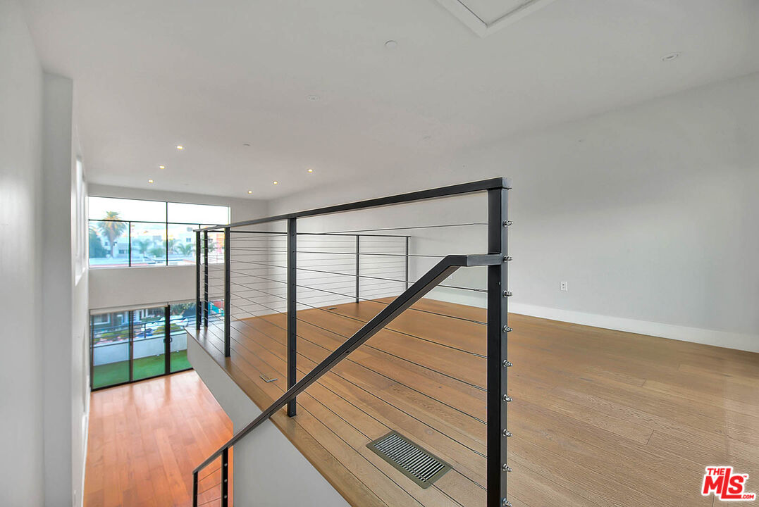 5014 Rosewood Avenue, Unit 1/2 Los Angeles, CA 90004 - Photo 12 of 45 a view of staircase with a floor to ceiling window and a glass door
