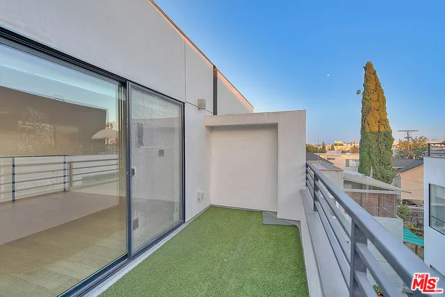 a balcony view with a backyard space