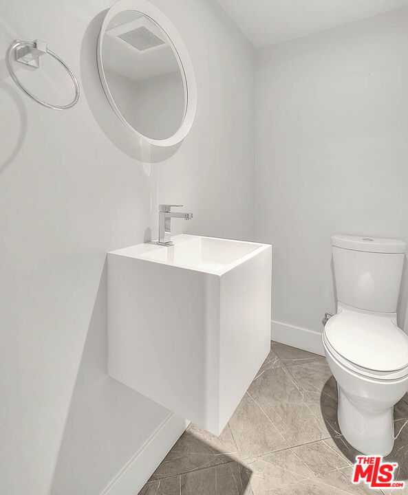 5014 Rosewood Avenue, Unit 1/2 Los Angeles, CA 90004 - Photo 17 of 45 a bathroom with a sink toilet and a mirror