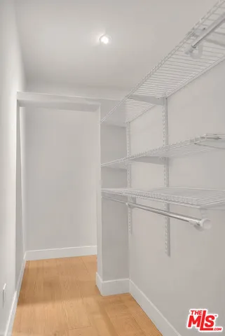 a bathroom with a sink a mirror and a shower