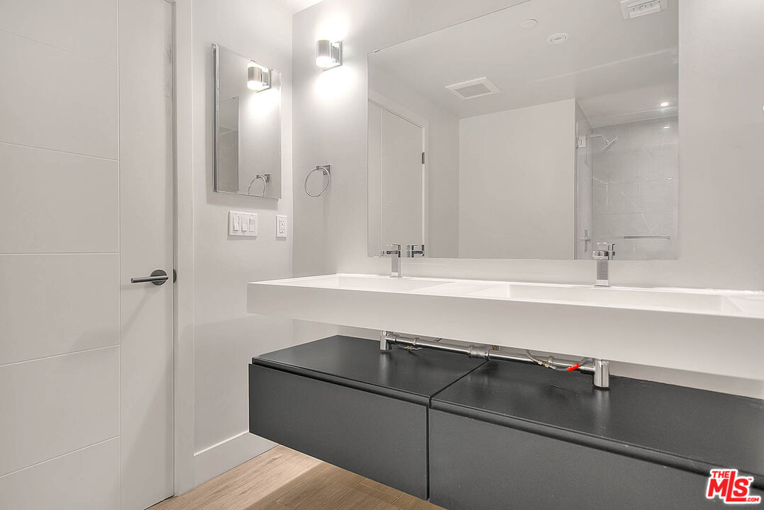5014 Rosewood Avenue, Unit 1/2 Los Angeles, CA 90004 - Photo 23 of 45 a bathroom with a sink and a mirror