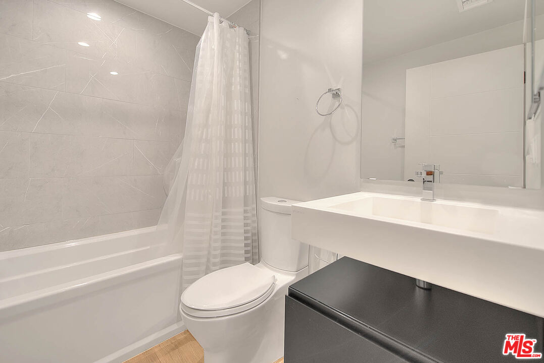 5014 Rosewood Avenue, Unit 1/2 Los Angeles, CA 90004 - Photo 27 of 45 a bathroom with a sink a toilet and shower