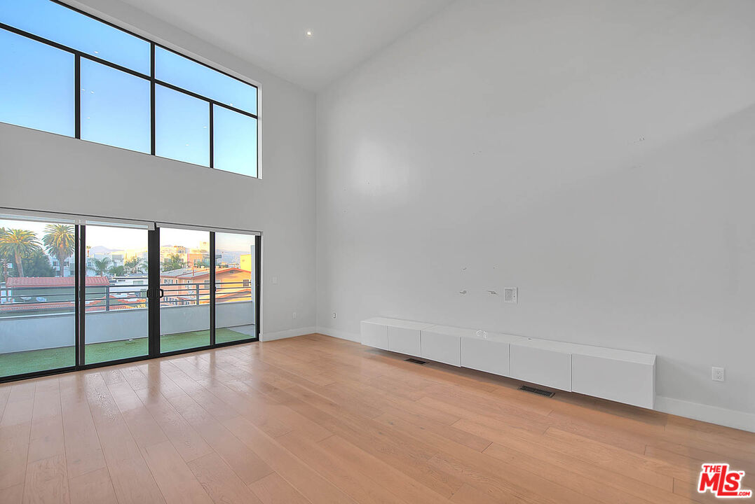 5014 Rosewood Avenue, Unit 1/2 Los Angeles, CA 90004 - Photo 3 of 45 an empty room with wooden floor and windows