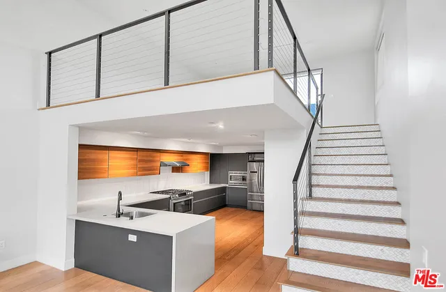 a view of kitchen and hall with wooden floor