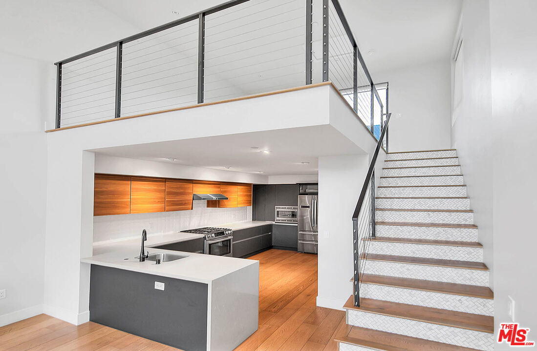 5014 Rosewood Avenue, Unit 1/2 Los Angeles, CA 90004 - Photo 6 of 45 a view of kitchen and hall with wooden floor