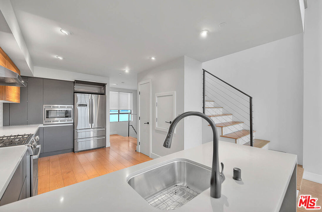 5014 Rosewood Avenue, Unit 1/2 Los Angeles, CA 90004 - Photo 7 of 45 a kitchen with refrigerator and stove
