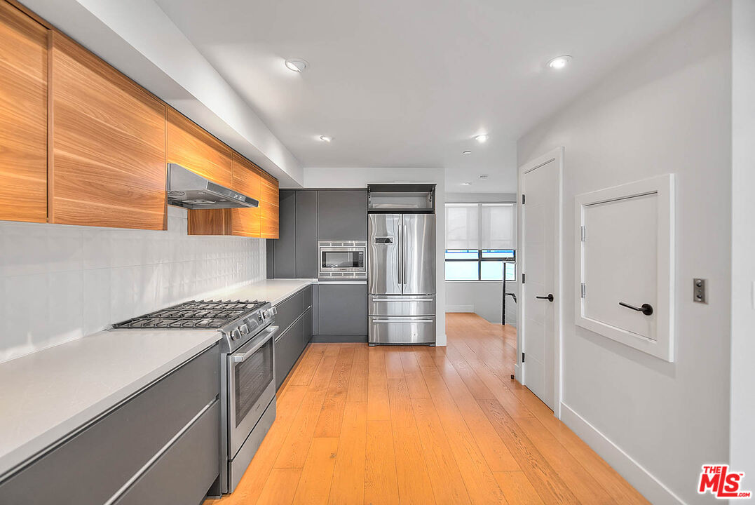 5014 Rosewood Avenue, Unit 1/2 Los Angeles, CA 90004 - Photo 8 of 45 a kitchen with granite countertop a sink cabinets and stainless steel appliances