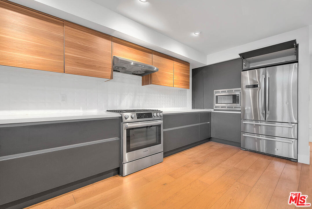 5014 Rosewood Avenue, Unit 1/2 Los Angeles, CA 90004 - Photo 9 of 45 a kitchen with stainless steel appliances a refrigerator and a stove