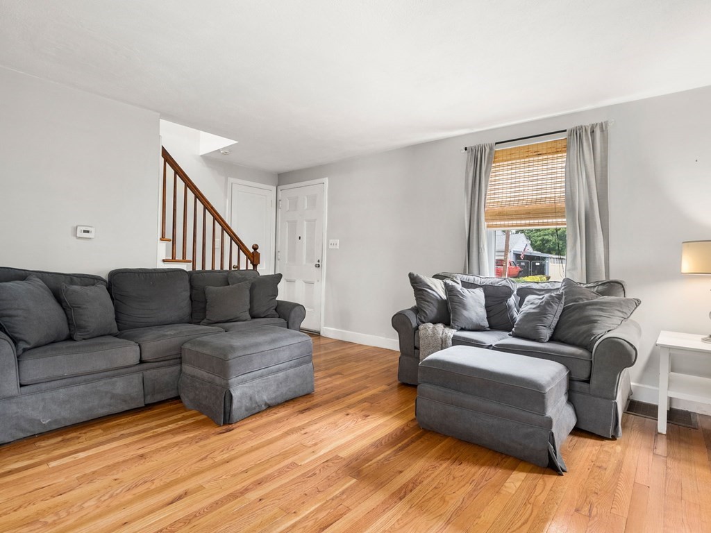 86 Anniversary Street Springfield, MA 01104 - Photo 11 of 31 a living room with furniture and a wooden floor