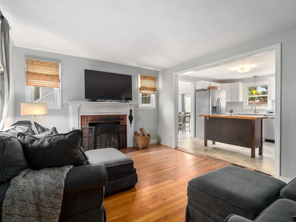 86 Anniversary Street Springfield, MA 01104 - Photo 13 of 31 a living room with furniture a flat screen tv and a fireplace