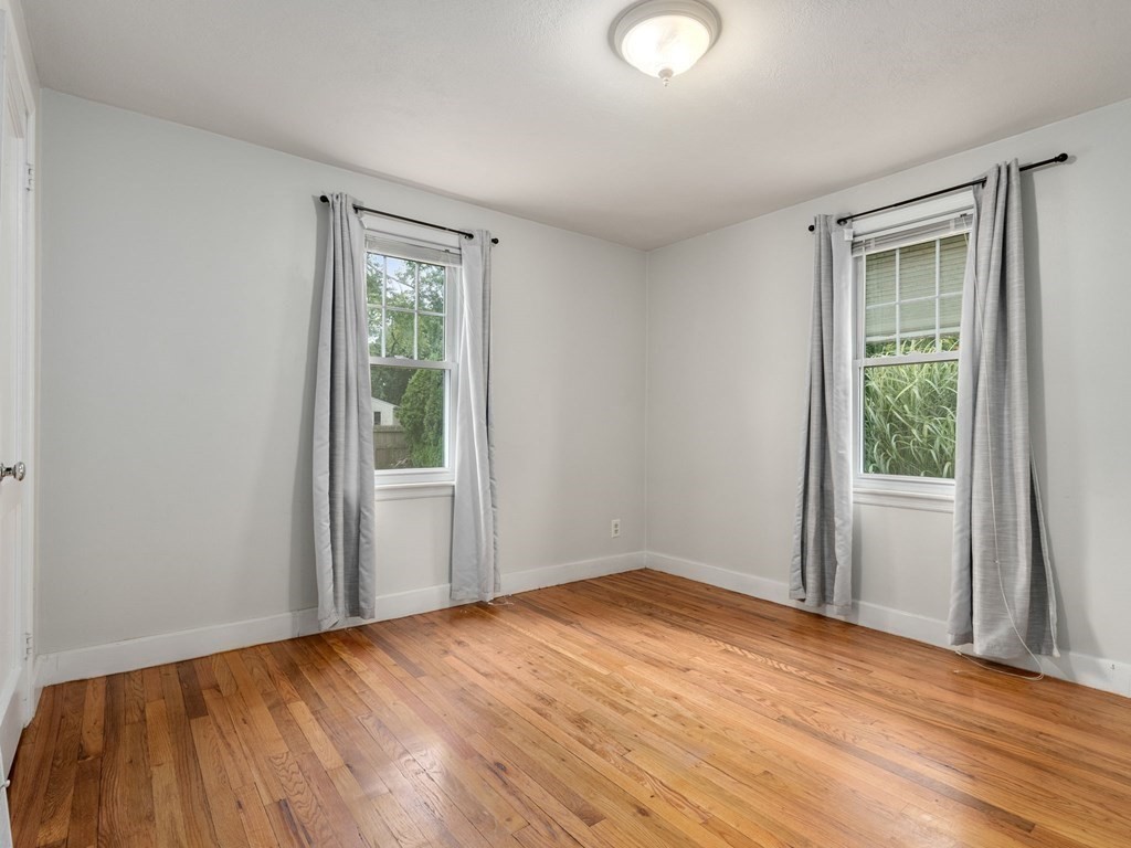 86 Anniversary Street Springfield, MA 01104 - Photo 17 of 31 a view of an empty room with wooden floor and a window