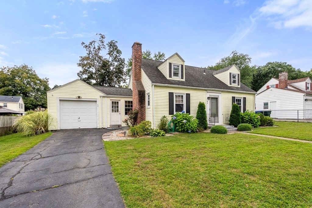86 Anniversary Street Springfield, MA 01104 - Photo 2 of 31 a front view of a house with a yard and garage