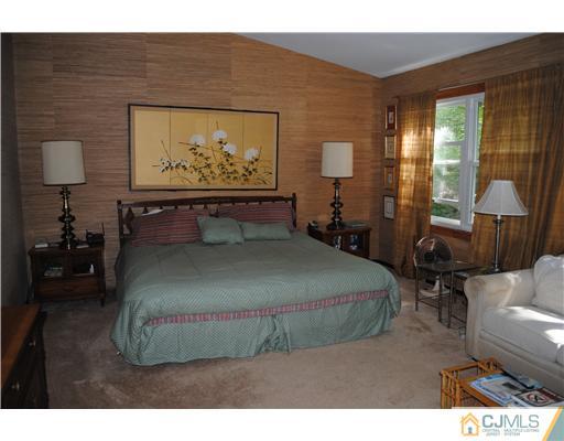 4 Tamarack Road Edison, NJ 08820 - Photo 8 of 19 a bed sitting in a bedroom next to a window