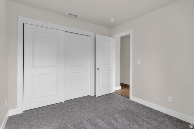 576 7th Avenue Midvale, UT 84047 - Photo 19 of 32 Unfurnished bedroom featuring carpet flooring and a closet