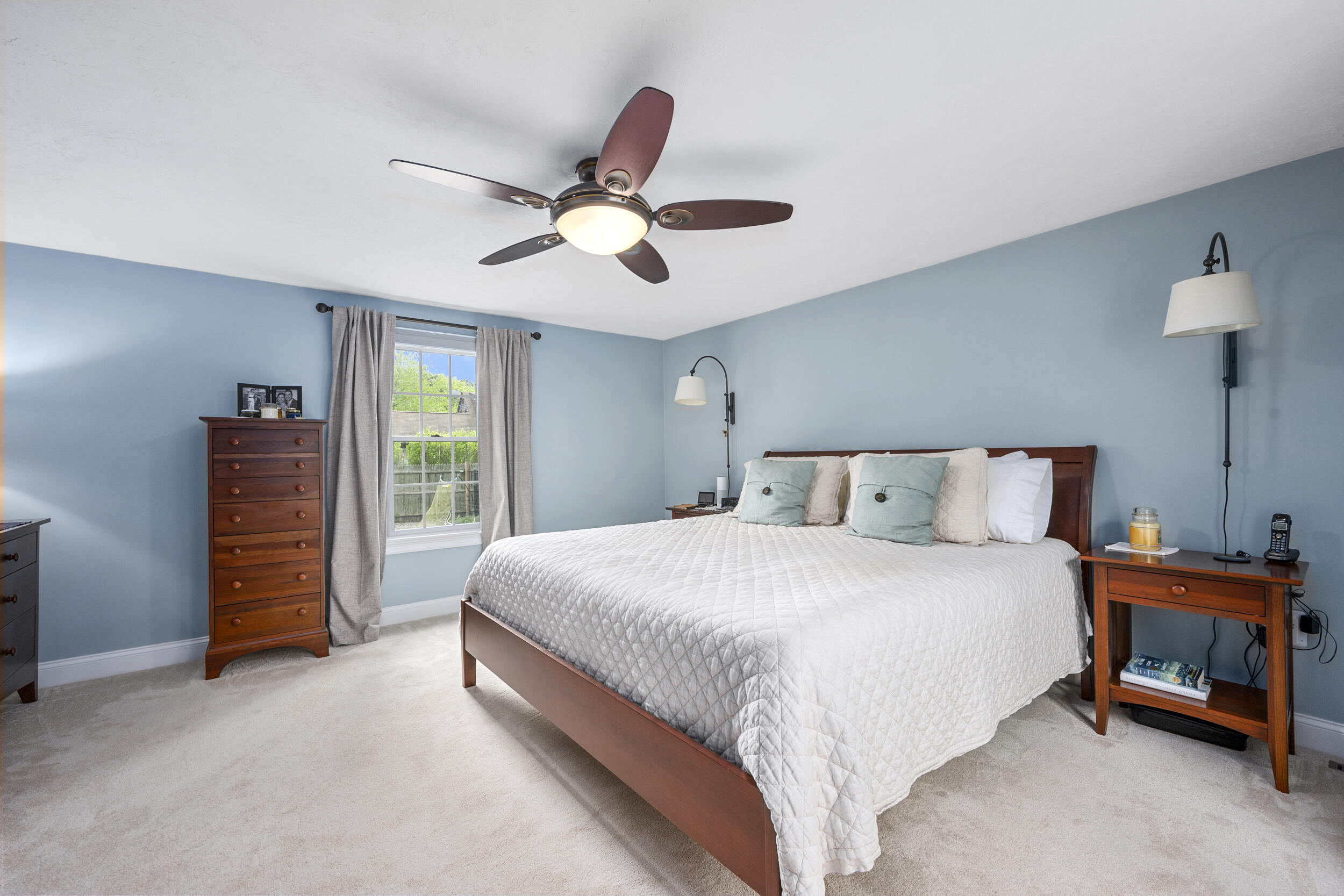 10 Neshobe Road Mashpee, MA 02649 - Photo 14 of 40 a bedroom with a bed and a chandelier