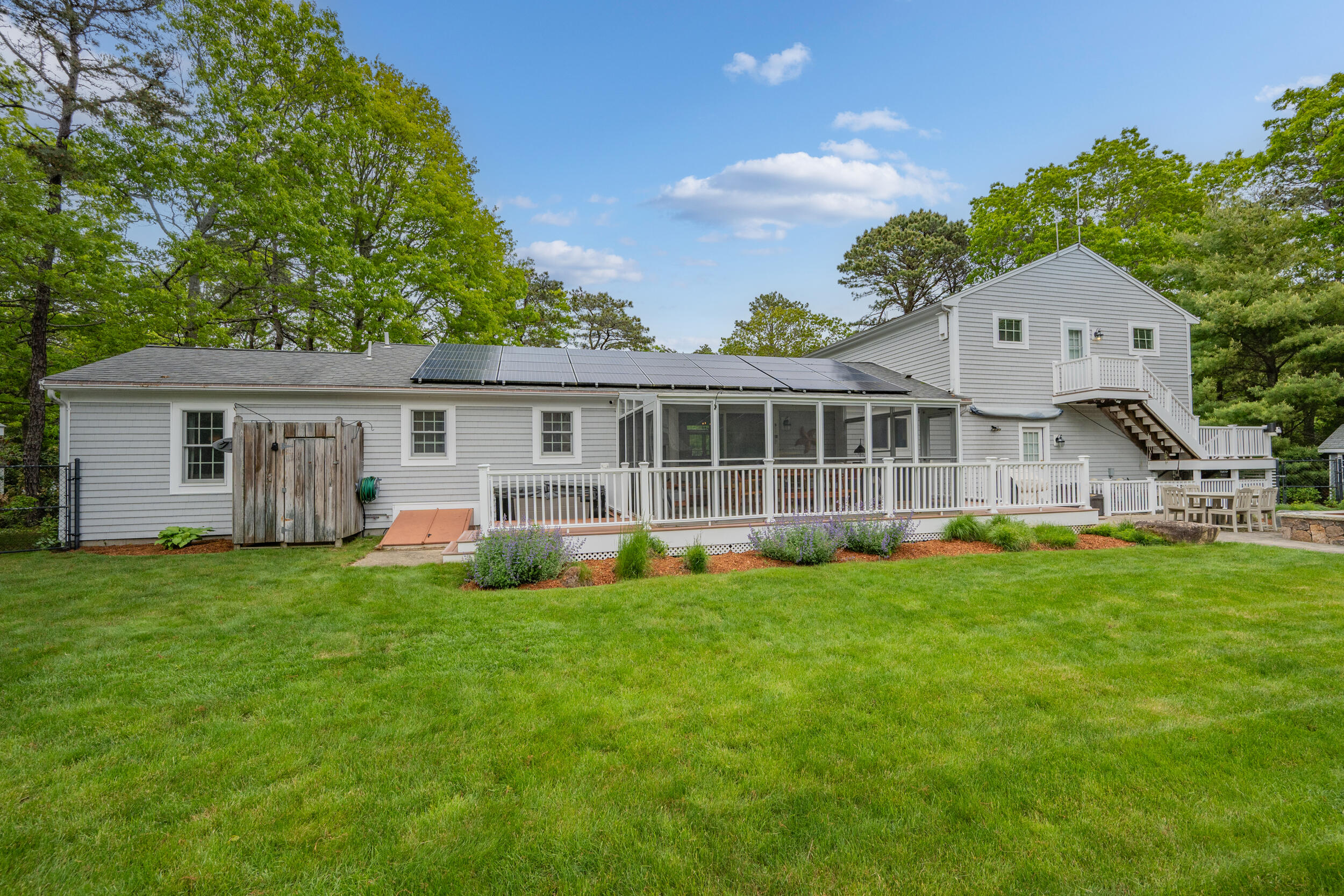 10 Neshobe Road Mashpee, MA 02649 - Photo 24 of 40 a view of a house with a yard and sitting area