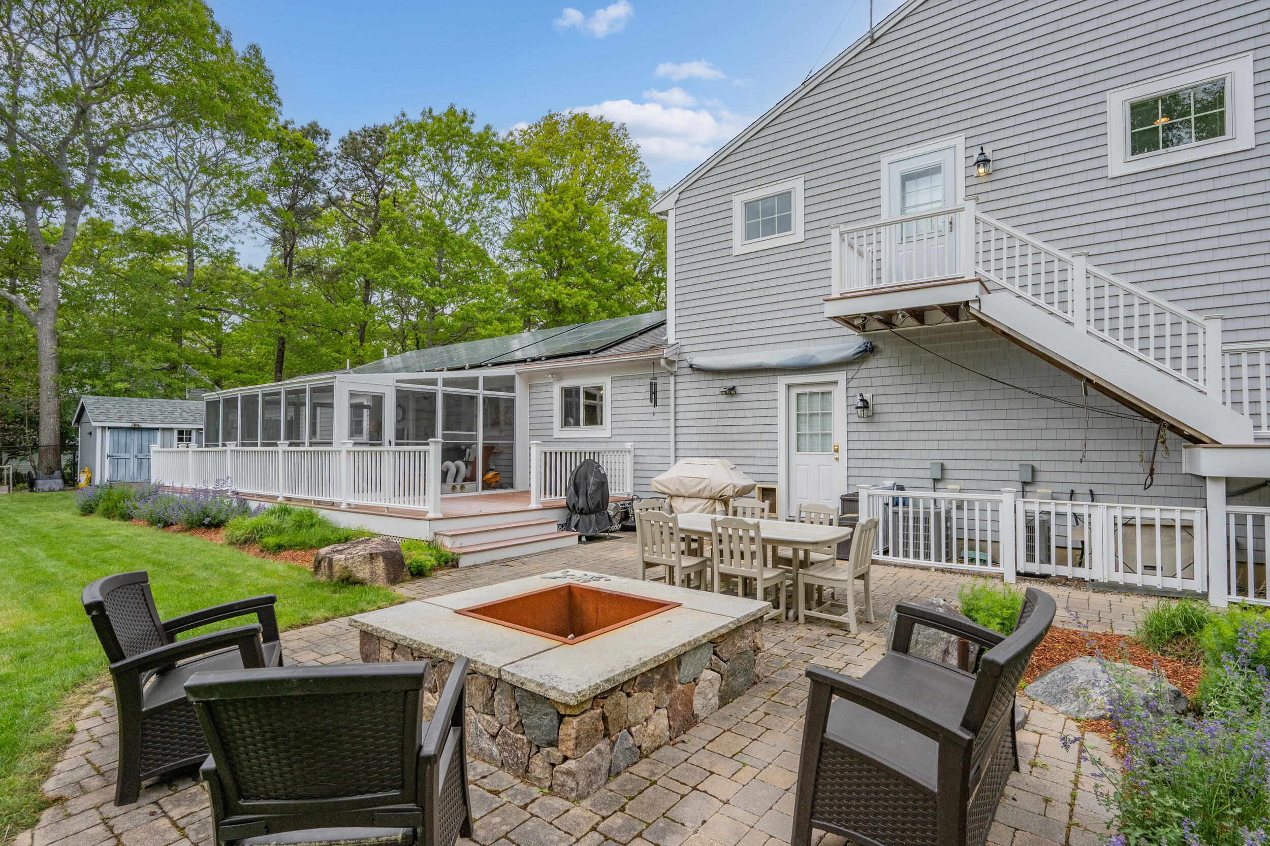 10 Neshobe Road Mashpee, MA 02649 - Photo 27 of 40 a view of a patio with table and chairs with wooden fence and plants