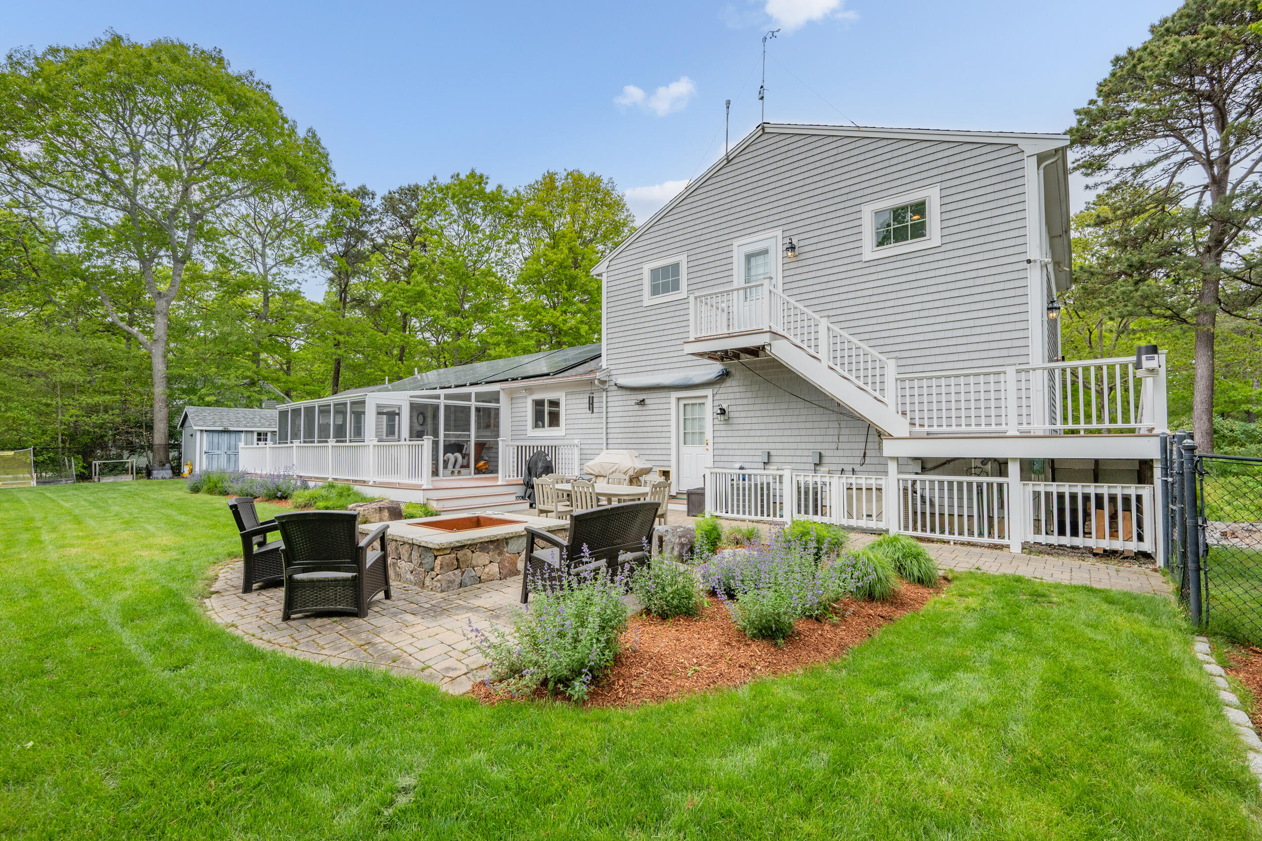 10 Neshobe Road Mashpee, MA 02649 - Photo 29 of 40 a front view of a house with garden and sitting area