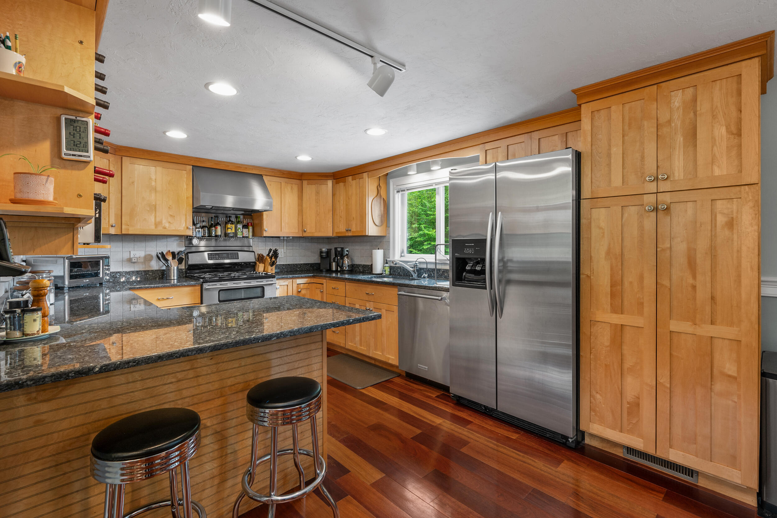 10 Neshobe Road Mashpee, MA 02649 - Photo 5 of 40 a kitchen with stainless steel appliances granite countertop a refrigerator a stove and a sink with wooden floor