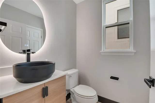 a view of a room with wooden floor and a ceiling fan