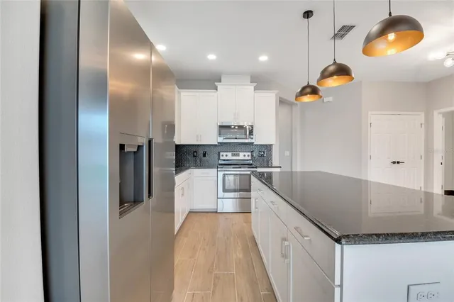 a spacious bathroom with a double vanity sink mirror and bathtub
