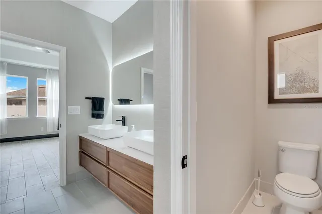 an aerial view of residential houses with outdoor space and parking