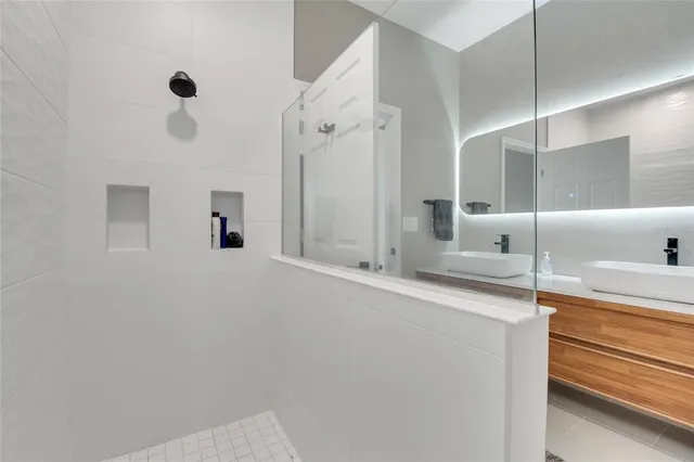 an aerial view of a house with a garden and lake view