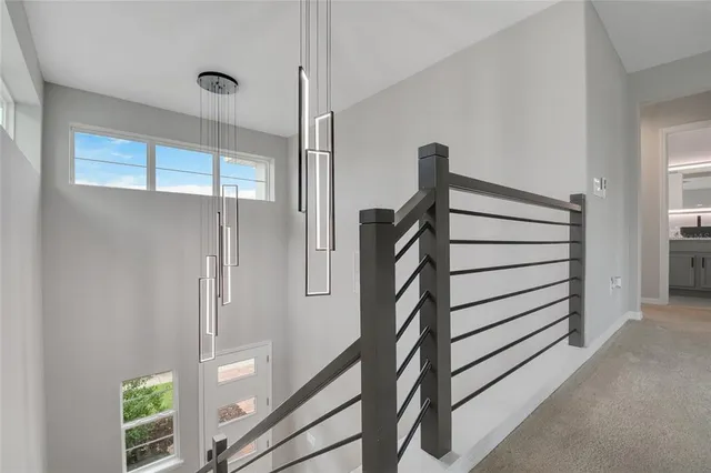 an aerial view of residential houses with outdoor space and parking