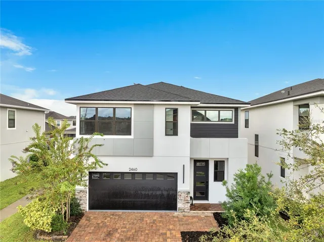 an aerial view of residential houses with outdoor space and ocean view
