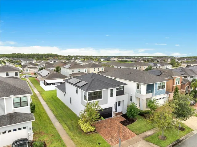 an aerial view of residential houses with outdoor space
