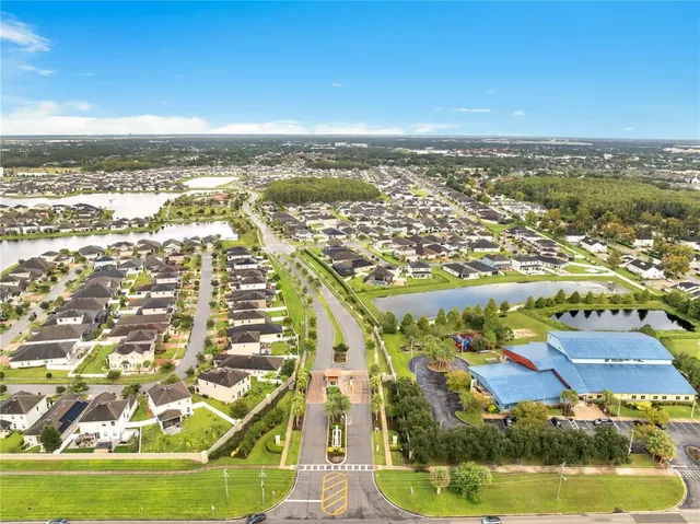 a kitchen with stainless steel appliances granite countertop a sink a stove and refrigerator