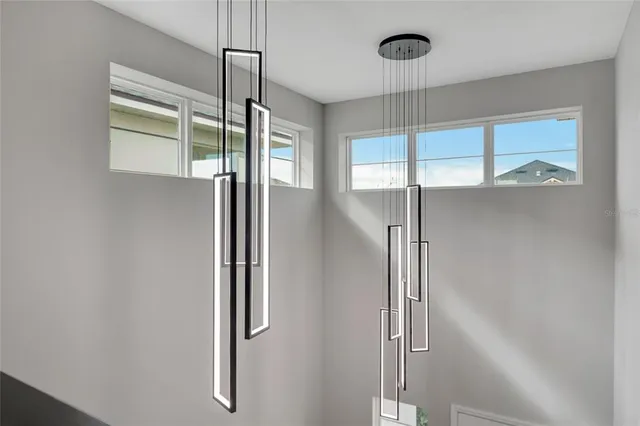 a large kitchen with stainless steel appliances a large counter top a stove and a wooden floors