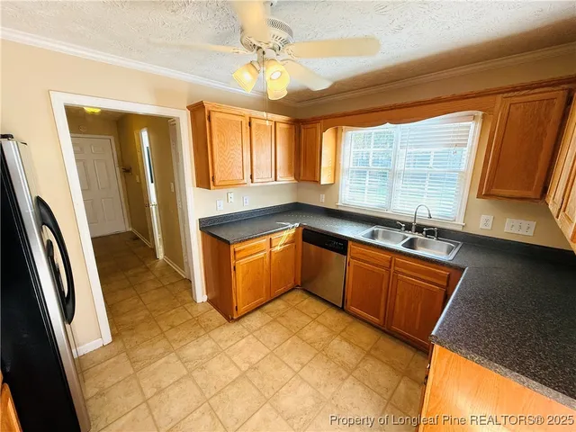 a large kitchen with stainless steel appliances granite countertop a sink stove and cabinets