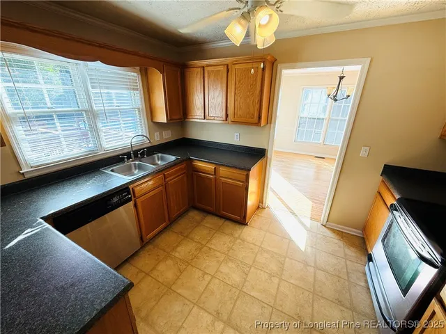 a kitchen with granite countertop a sink and a stove