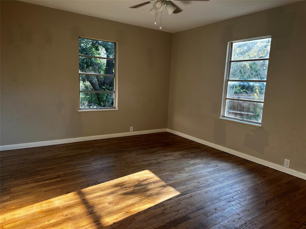 400 East Liberty Street Pilot Point, TX 76258 - Photo 7 of 16 Empty room featuring baseboards and wood-type flooring
