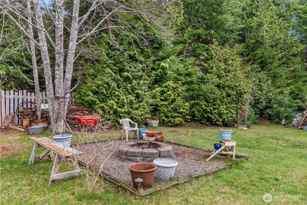 an aerial view of a house with swimming pool garden and trees