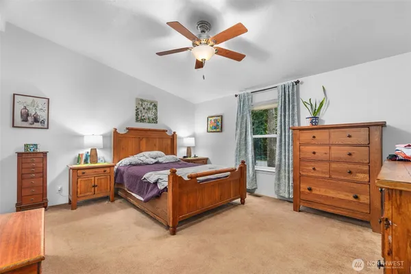 a bedroom with a bed closet and dresser