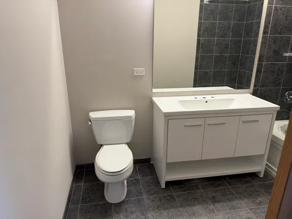 a bathroom with a sink toilet and a mirror