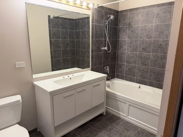 a bathroom with a sink a toilet and bathtub