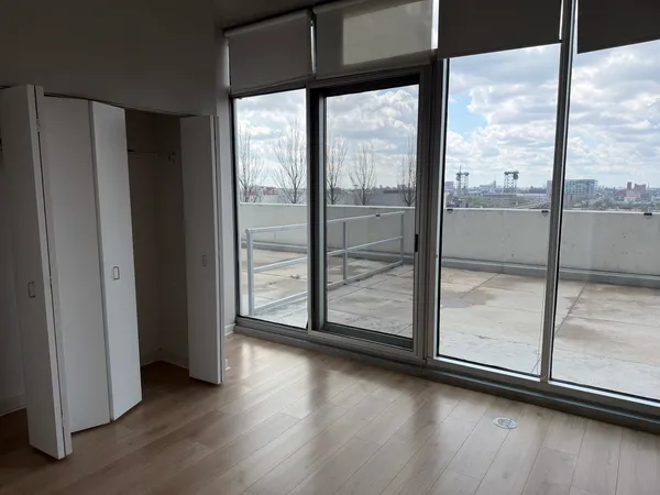 a view of a room with wooden floor and window