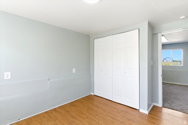 1613 Sunset Road Lake Point, UT 84074 - Photo 24 of 33 Interior room with wood-finish flooring and light gray painted walls