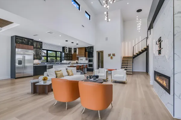 a living room with fireplace furniture and a wooden floor