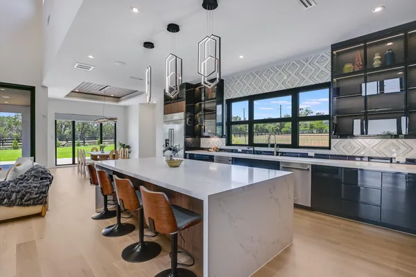 a kitchen with stainless steel appliances granite countertop a stove and a sink