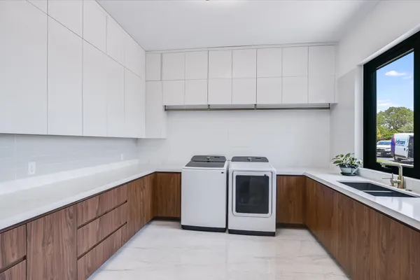 a kitchen with stainless steel appliances a sink stove and cabinets