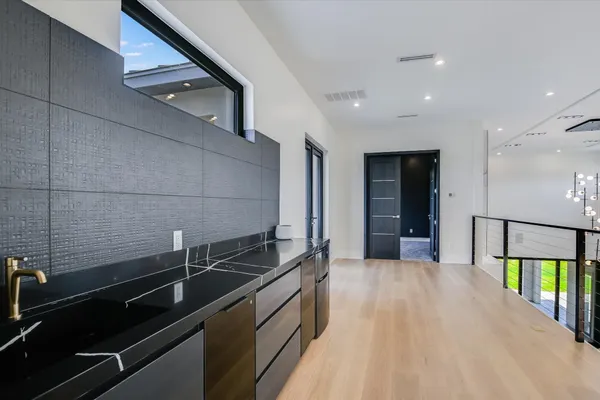 a kitchen with a sink and refrigerator