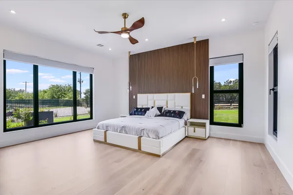 a spacious bedroom with a large bed and a large window