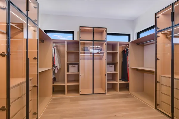 a view of walk in closet with empty racks
