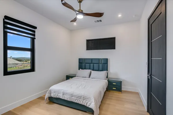 a bedroom with a bed and a flat screen tv