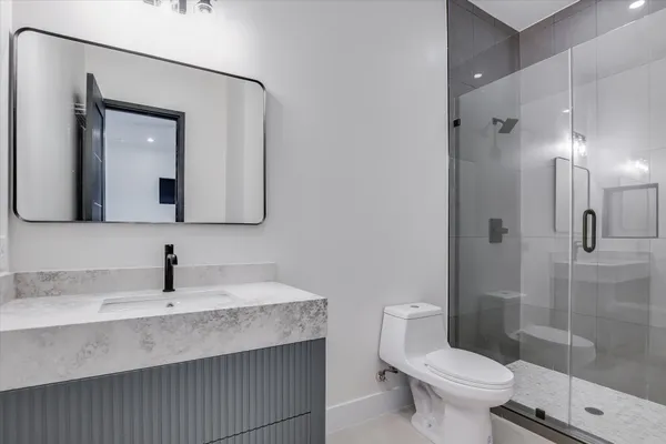 a bathroom with a toilet sink and shower